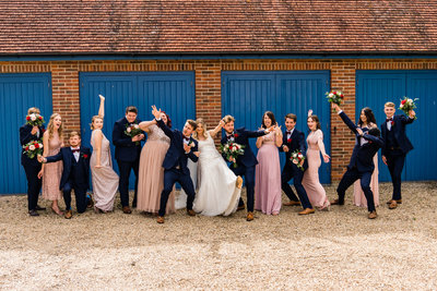 bridal-party-pulling-silly-poses-tithe-barn-perterfield