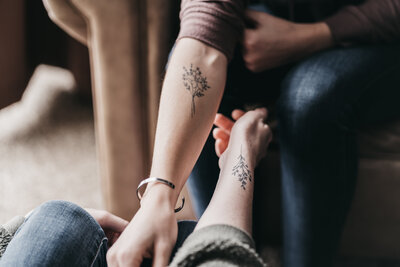 Detail shot of their matching flower tattoos.