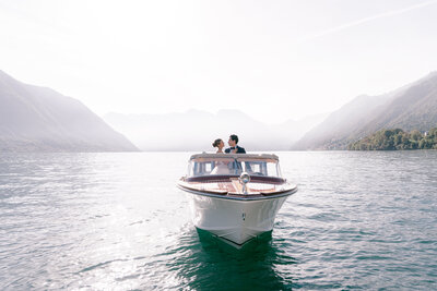 Couple on a boat in Lake Como for elopement by White Orchid Photography, destination wedding photographer