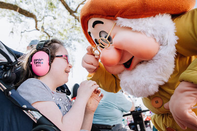 Girl smiles at Doc from Snow White at Disney