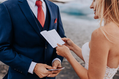 Destination elopement photographer captures bride reading vows during destination elopement