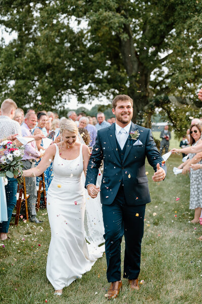 Kentucky bride and groom. Bride and groom ceremony flower petal toss