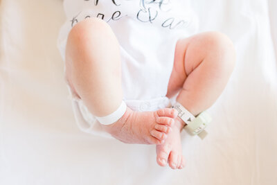 Newborn baby feet in hospital bassinet