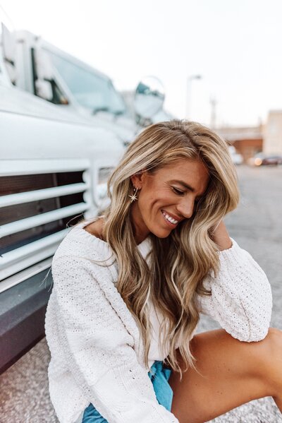 Girl smiling by trucks