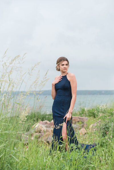 grad photo of girl by lake with tall grass