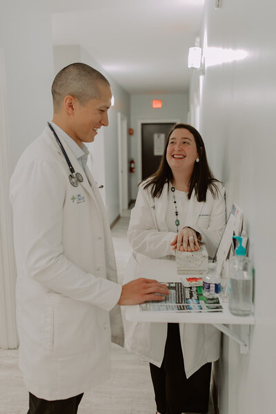 Two doctors standing in a hallway and talking