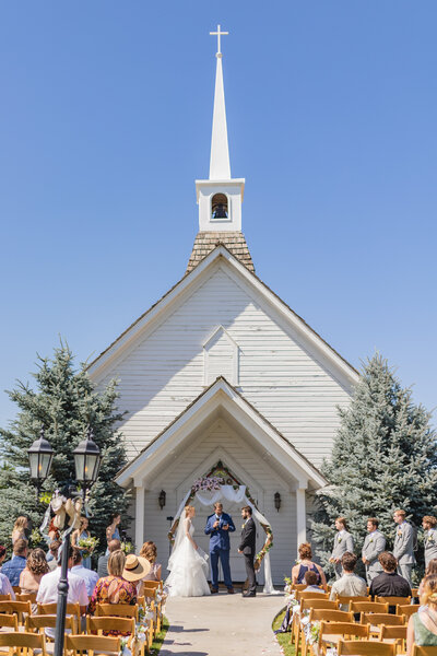 wedding ceremony at a white chapel