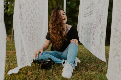 woman sitting on the ground and smiling