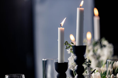 Lit candles with flowers at a DC event