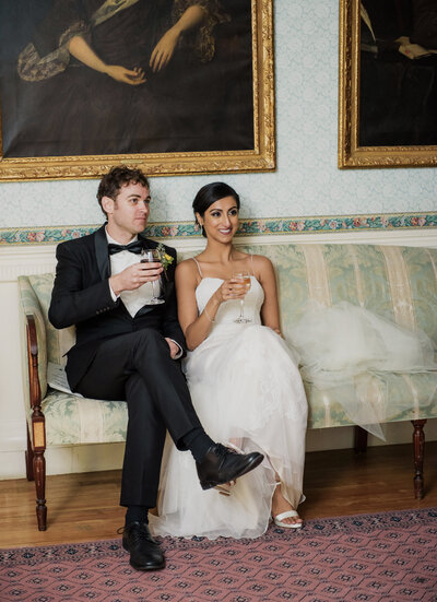 the best wedding photographers in boston feature their favorite curated highlights. stunning couple sitting with a drink.