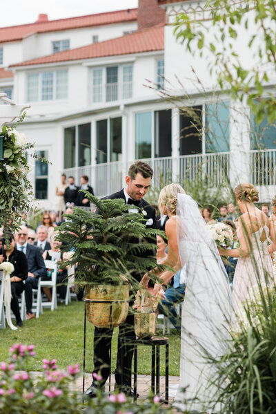 Couple put dirt in the unity tree during wedding ceremony