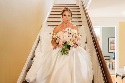 A bride on the staircase of Highrock Farms by Raleigh wedding photographer, JoLynn Photography