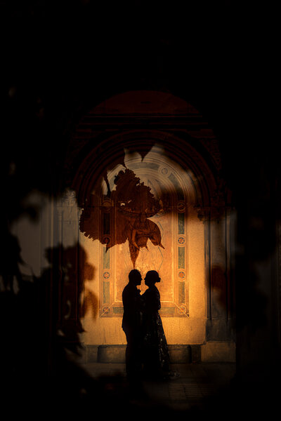 Silhouette of a couple standing close together.