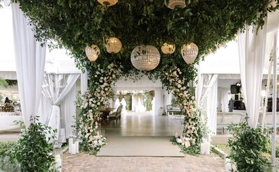 Reception Tent Entrance of floral arch and chandeliers