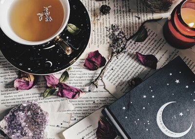Book, candle, tea cup, herb, crystals