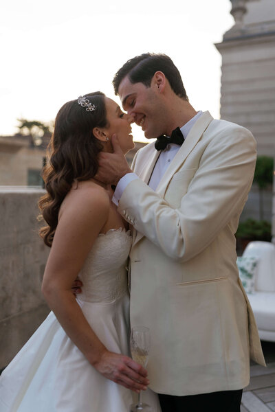 bride and groom kiss on the rooftop of the ned hotel during golden hour at their chic london wedding