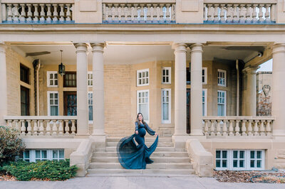 An Edmonton pregnant mom wearing a grey couture dress having fun at Alberta Government House