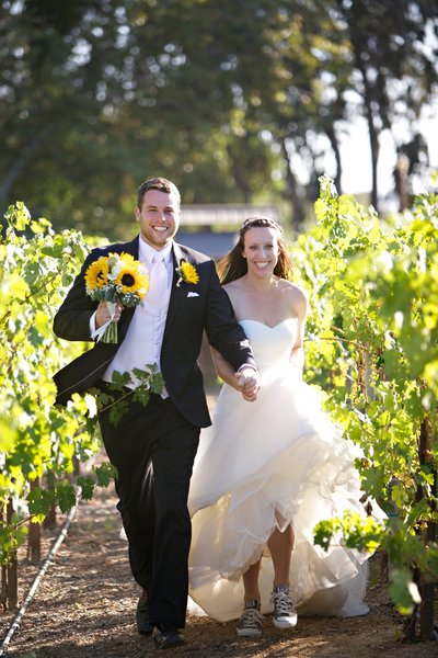 Bride and Groom running in the vineyard at Lake Oak Meadows