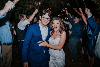 Destination Wedding Photographer captures couple embracing during  sparkler exit in Atlanta Georgia