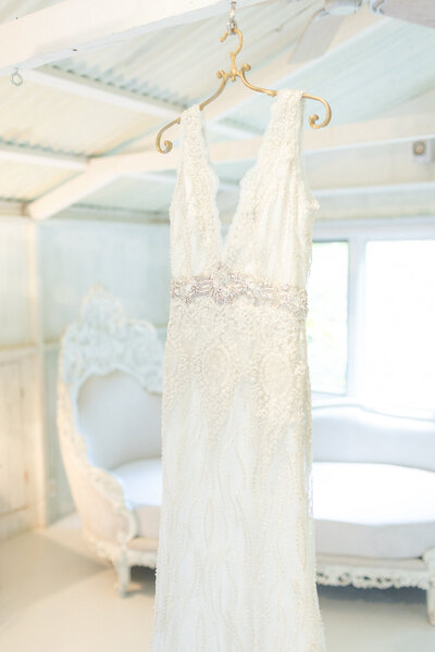 wedding dress hanging from roof