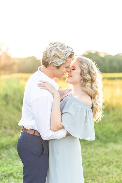 Hayes Sherr and Bree Thompson kissing in grass field.