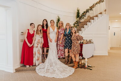 Bride and family members standing by staircase