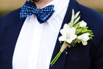white boutenniere on grooms navy suit, southern wedding