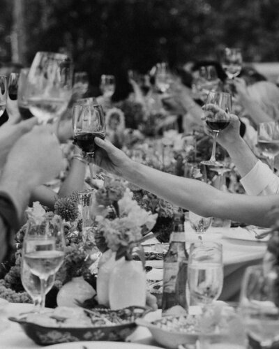 clinking glasses at wedding welcome dinner in jekyll island, georgia
