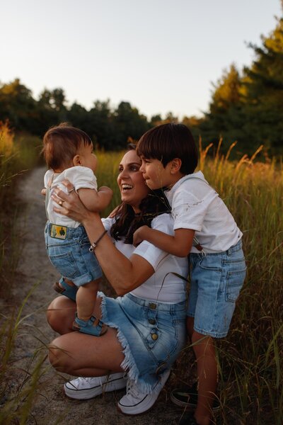 mother and her sons at a field during golden hour