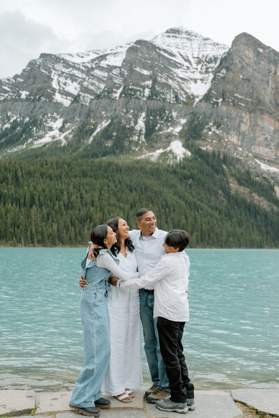 Family of four enjoying the sights of Lake Louise during a family photo shoot.