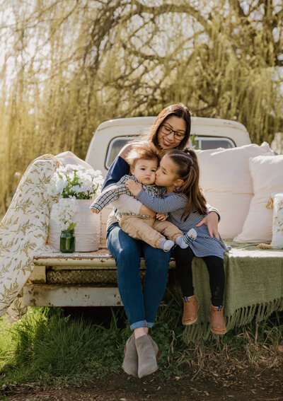 kids sitting with mom in a truck