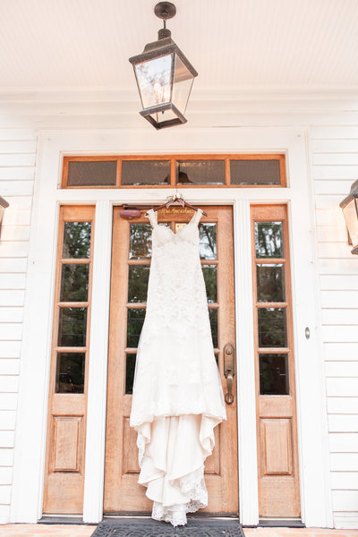 Photo of a wedding dress hanging at the Carl House by Jennifer Marie Studios.