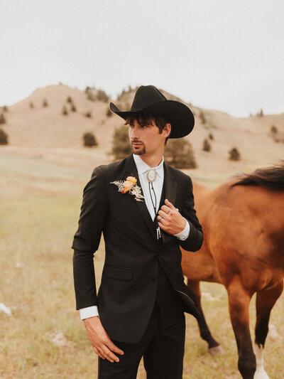 groom posing by horse