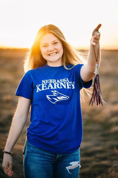 Senior attending University of Nebraska Kearney poses with her tassle