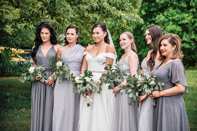 Bride and her bridesmaids holding their bouquets.