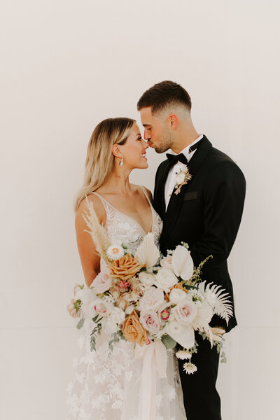 Couple with Groom Kissing Brides Nose - Bre & Chris | Converted Basketball Court Wedding – Featured in Brides Magazine