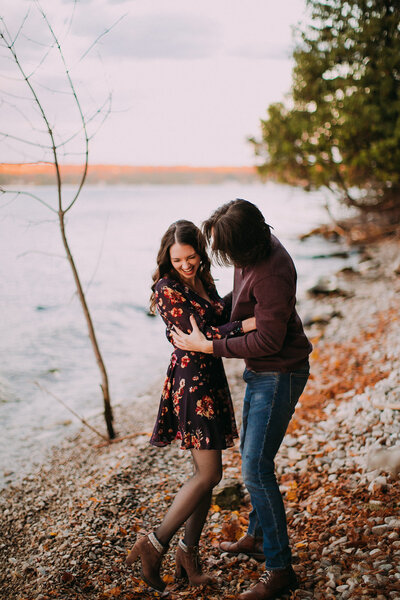 A man hugs a woman in Peninsula State Park Door County - Engagement Session