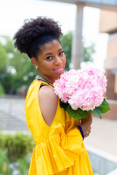 African American Woman Holding Pink Flowers