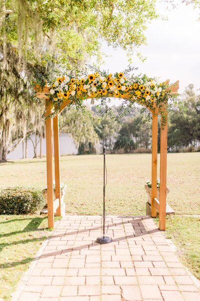 Wedding arch with sunflower arrangement