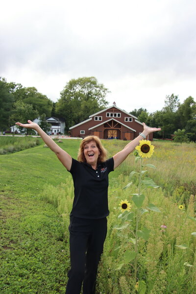 julie posing happily at barnwood events, a wedding venue in madison, winconsin.