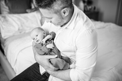 Dad holding newborn by Orlando Newborn Photographer