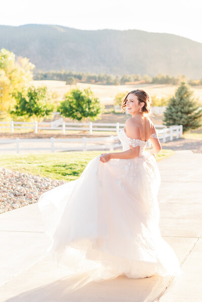 Kristine spins in her wedding gown during sunset portraits at Crooked Willow Farms.