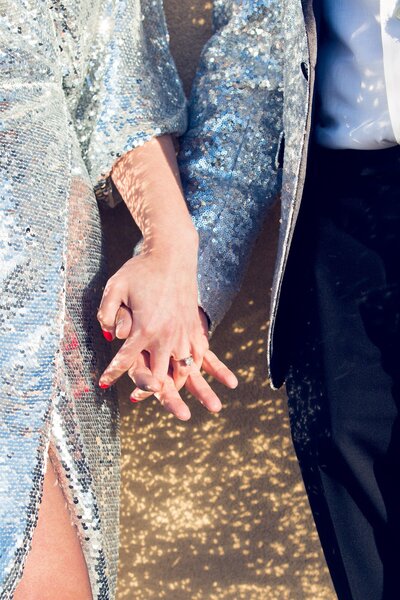 engaged couple holding hands