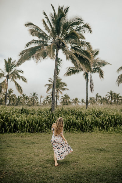 woman by palm trees