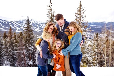 Loving family image in the snowy mountains