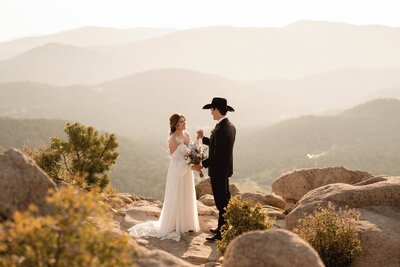 Couple hiking in the Colorado mountains on their wedding day