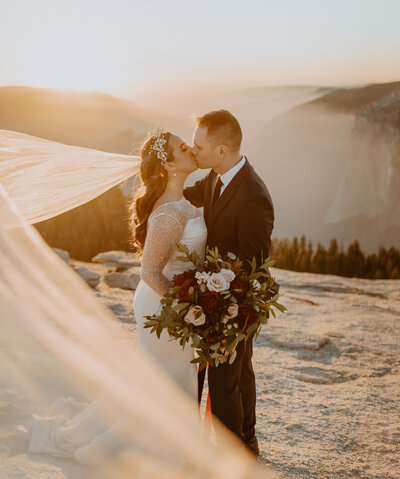 bride & groom on the edge of a cliff at yosemite