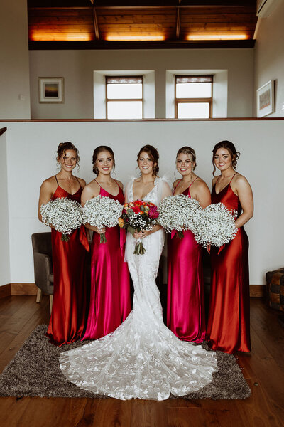 Red and orange dresses bridal party