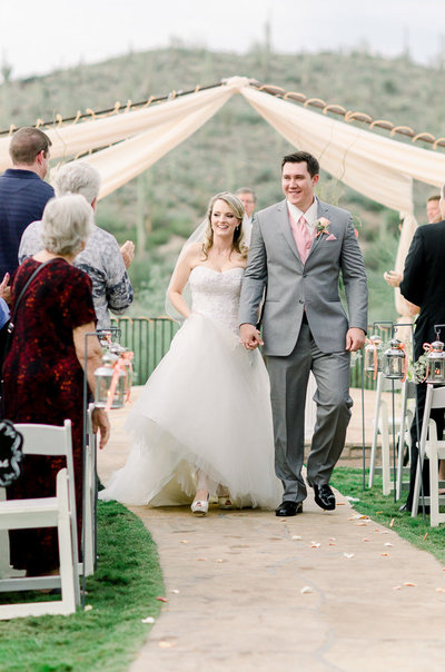 Saguaro Buttes Wedding Photo of Bride and Groom Walking Down the Aisle by Tucson Wedding Photographer Bryan and Anh | West End Photography