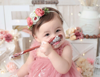 Sweet one year old eating cake at our studio in Rochester, Ny